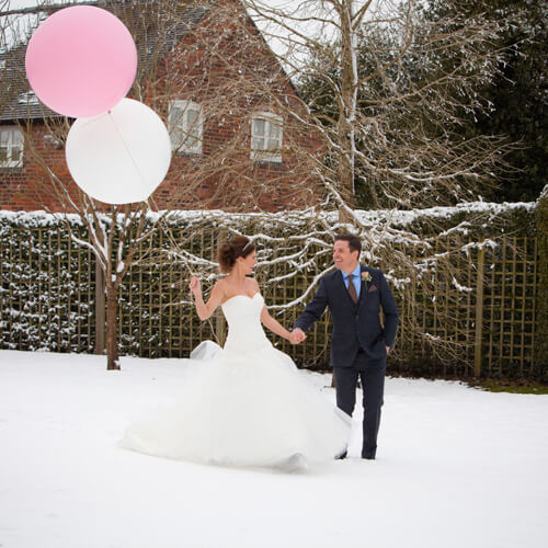 in snow with balloons